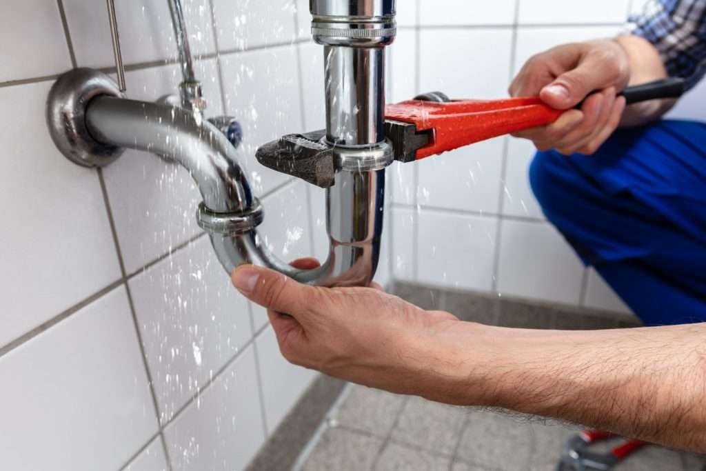 plumber fixing water leakage